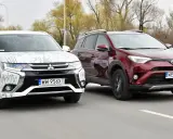 Dwa SUV-y, biały Mitsubishi Outlander i czerwony Toyota RAV4, jadące po drodze. Idealne dla szukających najmniej awaryjne SUV-y 10 letnie.