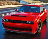 Czerwony Dodge Challenger Demon na torze wyścigowym, gotowy do startu.