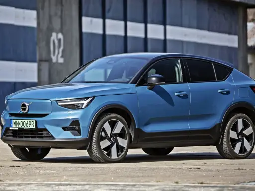 Niebieskie Volvo C40 Recharge, elektryczny SUV, parkuje przed budynkiem z numerem 02.