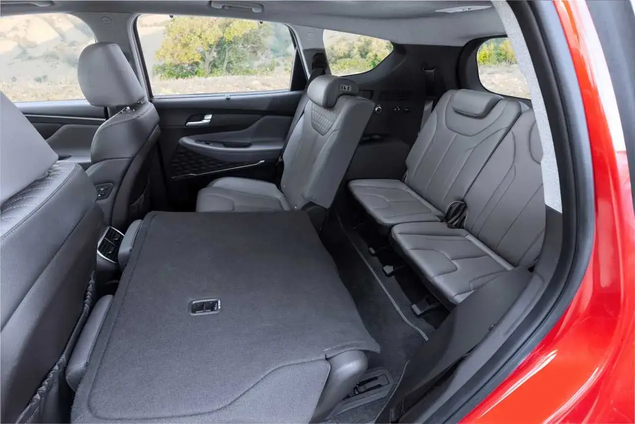 Wnętrze nowego Hyundai Santa Fe 2025 z rozłożonymi siedzeniami i dużą przestrzenią bagażową.